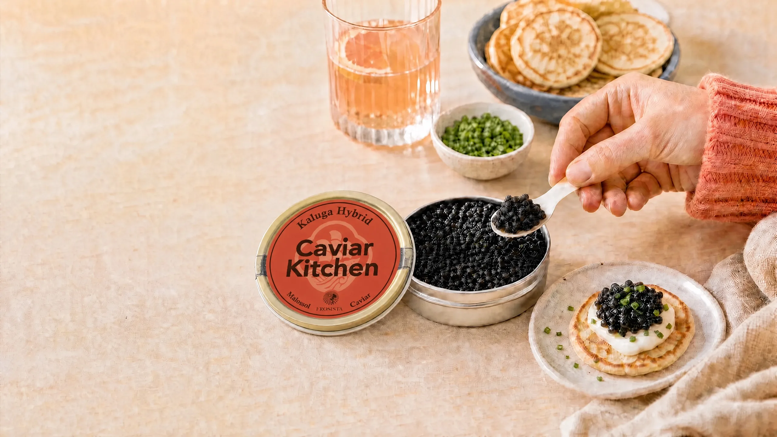 A tin of caviar served with a mother-of-pearl spoon.
